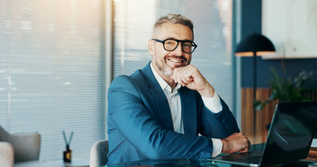 Happy, business and man with portrait in office for career pride, about us and finance consultant. Mature person, laptop and thinking for planning, schedule update and ideas for investment proposalの写真素材