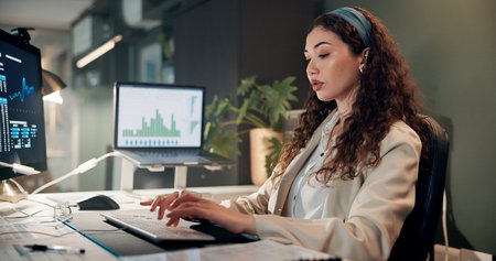 Woman, typing and computer with trading, graphs and review for revenue report in office at company....