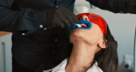 Appointment, hands and mouth of patient with dentist in office for checkup, cleaning or operation....
