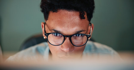 Business, man and reading on computer in office of research, feedback email and financial report. Male person, glasses and pc online with budget review, finance information and data entry of proposalの写真素材