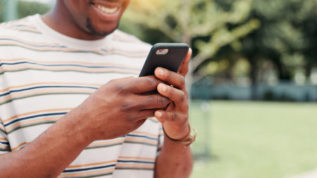 Outdoor, hands and man with smartphone, texting and happy for message on app, communication and...