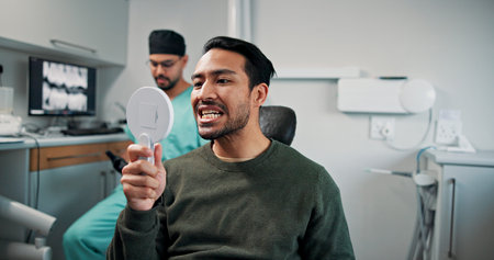Man, mirror and dentist with teeth for dental care, hygiene or oral treatment at orthodontist. Male...