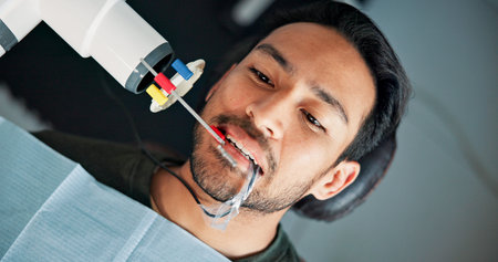 Above, medical x ray and patient in dentist office for checkup or mouth operation. Dental hygiene,...