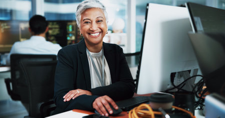 Portrait, woman and developer with computer in office for programming, software update and IT career. Mature person, pc and coding pride for website development, testing server and system applicationの写真素材