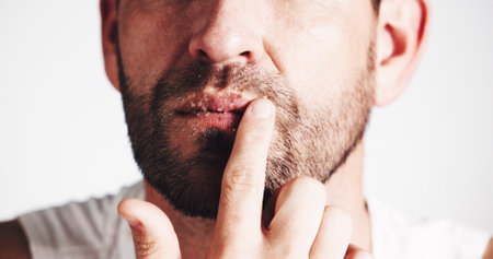 Beauty, lip scrub and sugar with man in studio for exfoliation, spa treatment and skincare. Cosmetics, facial and dermatology with closeup of person on white background for self care and glowの写真素材