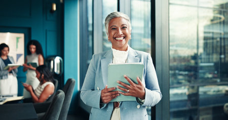 Office, mature and businesswoman with tablet in portrait, news story and notification for blog post. Newsroom, female person and editor with technology for publication, article website and happinessの写真素材