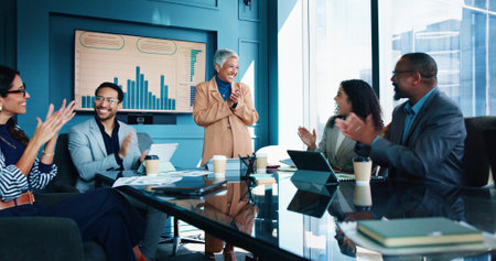 Applause, presentation and business people in meeting, graphs and profit growth. Speaker, group and employees in workplace, investment and clapping for bonus, company revenue and charts with smileの写真素材