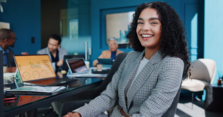 Portrait, smile and business woman in office meeting for finance, investment or quantitative analyst. Corporate, confident professional and happy worker coworking for risk management or data analysisの写真素材