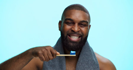 Black man, smile and portrait with toothbrush for brushing teeth, dental health or bamboo in studio....