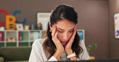 Anxiety, education and laptop with woman teacher at desk in office for burnout or stress. Computer, headache and tired with mature educator at school for fatigue, migraine or planning of curriculumの写真素材