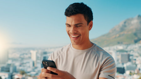 Happy man, fitness or typing with phone in nature for social media, workout app or connection. Active, male person or user with smile on mobile smartphone for network, exercise or health and wellnessの写真素材