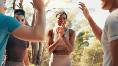 Happy people, fitness and applause with high five in nature for workout goals, winning or teamwork. Active, group or friends clapping with smile for success, exercise or health and wellness togetherの写真素材