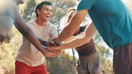 Fitness, huddle and running with friends outdoor together for bonding, motivation or support. Excited, exercise and stack of hands with group of people in circle for practice, training or workoutの写真素材