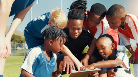 Soccer, children and coach with clipboard for team, training and formation on field. Man, football group and planning game for strategy, discussion and exercise for tournament or goal practiceの写真素材