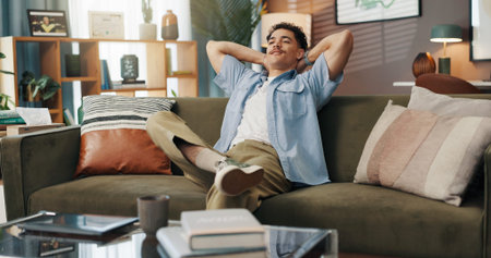 Stretching, relax and man on couch, home and smile for break on weekend, calm or peace in living...