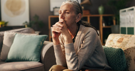 Senior woman, thinking and doubt with memory on sofa for dream or ambition at old age home. Elderly,...
