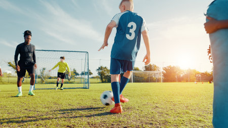 Practice, soccer player and children with ball, coach and athlete with energy for training in morning. Sports field, football and kids with sportswear for game, growth and development with fitnessの写真素材