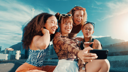 Gen z girl, selfie and friends on bridge, edgy clothes or smile for bonding in streetwear for fashion in summer. Women, group and happy with photography, post or trendy style for social media in cityの写真素材