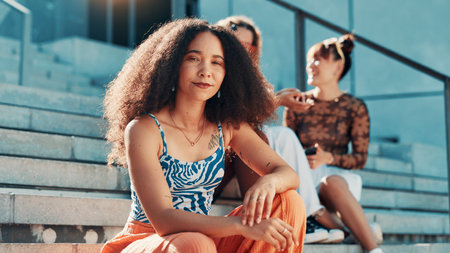 Fashion, confident or woman in city on steps in trendy clothes, casual outfit or modern style. Friends, relax and proud female person on stairs in urban town for holiday, portrait or outdoor vacationの写真素材