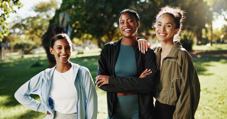 Portrait, women or athlete friends in park on break in outdoor training, workout or support in morning. Proud girls, confidence or happy people with smile for fitness, teamwork or exercise in natureの写真素材