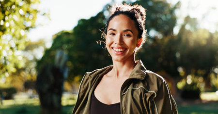 Fitness, woman and smile with portrait at park for morning workout, cardio exercise or ready for marathon. Athlete, runner and happy in nature for wellness routine, running self care or sports prideの写真素材