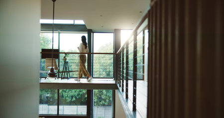 Break, business and coffee with woman in home office for professional career as journalist or publisher. Balcony, glass window and walking with freelance employee in apartment for remote workの写真素材