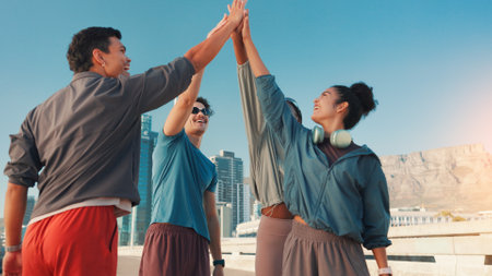Happy people, fitness and huddle with high five in city for workout goals, motivation or success. Active, group or friends with hands together for teamwork, exercise or achievement in an urban townの写真素材