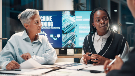 Machine learning, business people and planning in meeting, ai project and brainstorming for software update. Employees, IT specialist or expert in office, discussion and proposal for b2b deal or talkの写真素材