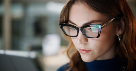 News, reading or businesswoman with glasses with tablet for accounting online, economy and finance. Accountant, check or financial advisor with technology for revenue, research and investment updateの写真素材