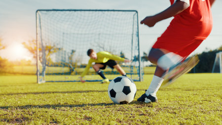 Goal, soccer player and children with ball, kick and athlete with energy, cardio and practice in morning. Sports field, football and kids with sportswear for game, growth and development with fitnessの写真素材