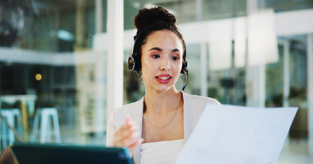 Headset, laptop and agent with document in virtual meeting for investment advice, risk management or report feedback. Office, financial advisor or online webinar for finance plan development and helpの写真素材