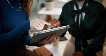 Business people, hands or pointing with tablet at night for project deadline or research at office. Closeup, employees or colleagues working late with technology for design strategy, review or reportの写真素材