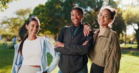 Portrait, women or fitness friends in nature on break in outdoor training, workout or support in morning. Proud girls, athletes or happy people with smile for confidence, teamwork or exercise in parkの写真素材