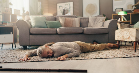 Senior woman, faint and floor at house for heart attack, cardiac arrest and medical accident. Unconscious, walking stick and elderly person with disability for stroke emergency, healthcare problemの写真素材