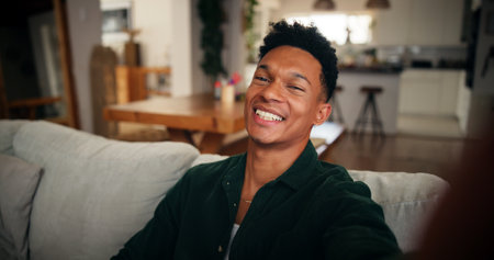 Man, laugh and selfie in home for social media, influencer or content creation for happiness in picture. Live stream, followers and person with funny memory, update or post for photography portraitの写真素材