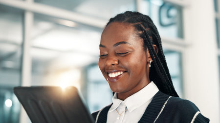 Smile, business and black woman with tablet for reading email, report or insurance policy premium in office. Digital technology, online or worker on app for coverage, risk management or review claimsの写真素材