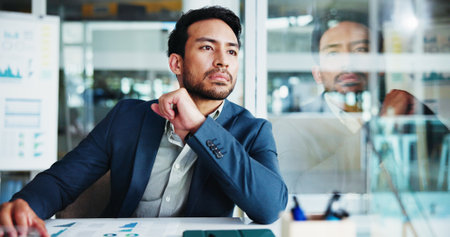 Man, thinking and finance at office with decision for budget, solution and review by glass. Person, charts and perspective with reflection for graphs, problem solving or choice at accounting agencyの写真素材