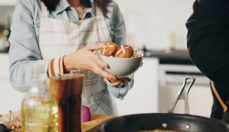 People, hands and cooking with bowl of mushrooms for vegetarian snack, ingredients or meal prep at home. Chef, assistant and vegan recipe with organic vegetables or food for hospitality at houseの写真素材