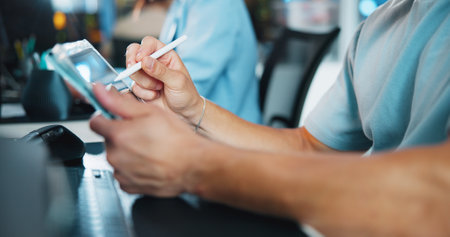 Tablet, programmer and stylus with hands of person in office for game designer, coding app and ux update. Software development, graphics upgrade and level gameplay with closeup of employee in agencyの写真素材