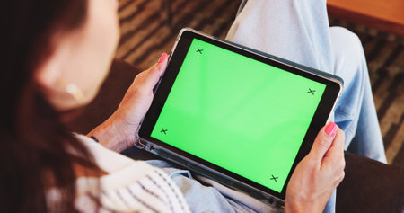 Green screen, sofa and woman in home on tablet for research, browse website and internet. Mockup space, lounge and above of person on digital tech for email, connection and media at tracking markersの写真素材