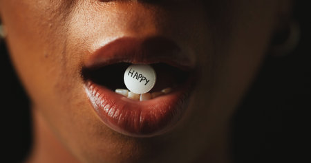 Mouth, tablet and addiction in studio closeup with text for mind altering drugs by black background....