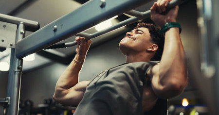 Fitness, man and exercise on pull up bar at gym for shoulder muscle, bicep strength or bodybuilding...