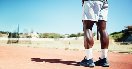Legs, athlete and man for fitness at stadium for training, exercise and marathon practice on track...