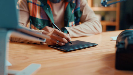 Person, hands and editor with tablet pen for drawing, sketching or digital design at home. Closeup,...