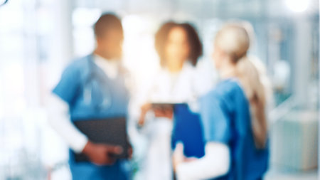 Blur, medical or meeting with doctors and nurses in hospital together for discussion or report. Collaboration, conversation and healthcare with professional medicine team in clinic for diagnosisの写真素材