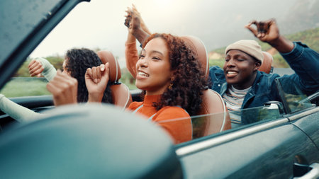 Dance, drive and road trip with happy friends in car together for holiday, travel or vacation. Energy, freedom and music with group of people riding in convertible vehicle for weekend getawayの写真素材