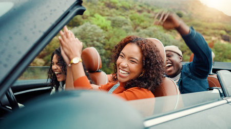 Clapping, dance and road trip with happy friends in car together for holiday, travel or vacation. Drive, music and smile with group of people riding in convertible vehicle for weekend getawayの写真素材