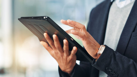 Hands, person and typing on tablet in office for research, financial report and schedule update....