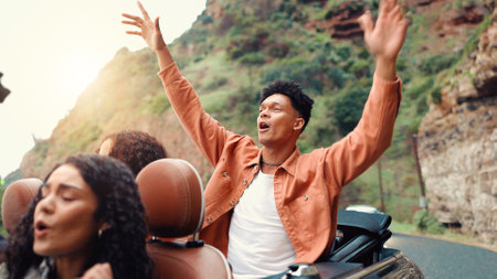 Arms raised, drive and road trip with happy friends in car together for holiday, travel or vacation. Energy, excited and freedom with group of people riding in convertible vehicle for weekend getawayの写真素材