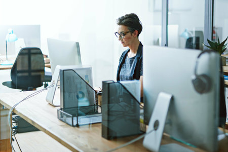 Woman, working and computer or serious in office, business analyst and corporate worker with online statistics report. Technology, internet research and professional, information results and employeeの写真素材